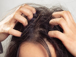 Hands scratching itchy scalp or head
