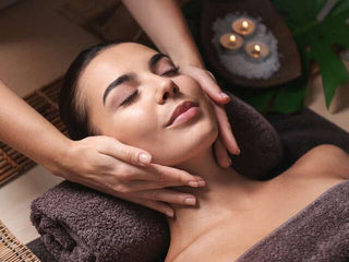 Woman receiving facial massage treatment at Leor Clinic