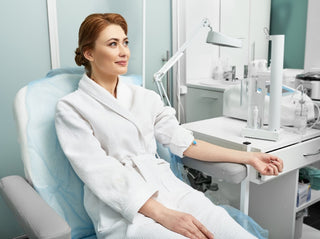 Woman in robe, IV drip treatment in clinic