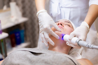 Woman receiving laser facial treatment